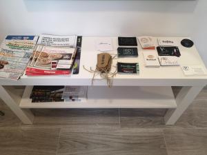 a white table with magazines and books on it at Madrid Green in Villaviciosa de Odón
