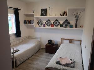 a bedroom with two beds and a window and shelves at Madrid Green in Villaviciosa de Odón +68 photos