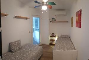 salon z kanapą i wentylatorem sufitowym w obiekcie Beachfront 82 w mieście Torrox Costa +24 zdjęcia