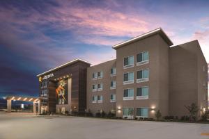 a rendering of a hotel with a building at La Quinta Inn & Suites by Wyndham Lewisville in Lewisville