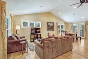 a living room with two couches and a television at Borrowed Thyme in Saugatuck
