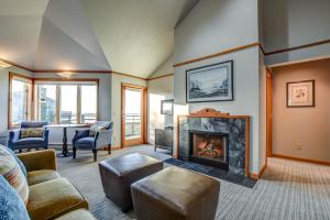 a living room with a fireplace and a table at The Waves in Cannon Beach