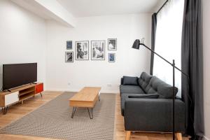 sala de estar con sofá y TV en Oktheway Montealto, en A Coruña