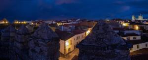 a view of a city at night at Portas da Villa in Miranda do Douro