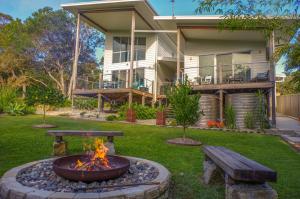 a backyard with a fire pit and a house at Drifted Away in Valla Beach