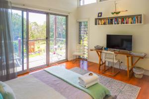 a bedroom with a bed and a desk and a television at Drifted Away in Valla Beach