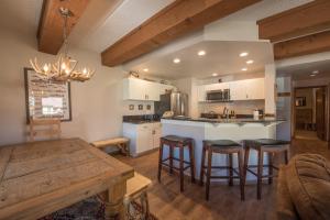a kitchen with a table and some bar stools at Rustic-Contemporary 3Br With Great Views Condo in Crested Butte