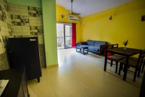 a living room with a table and a couch at Mariners Bay Resort in Mandrem