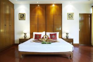 Posteľ alebo postele v izbe v ubytovaní PP Erawan Palms Resort