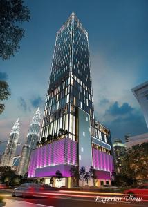 a tall building with a purple facade in a city at Tropicana The Residences KLCC by Vale Pine in Kuala Lumpur