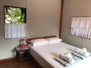 a bedroom with a bed with two towels on it at BAANYA HOMESTAY Ko Kret in Nonthaburi