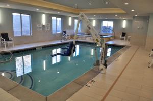 a large swimming pool in a building at Holiday Inn Express & Suites Price by IHG in Price