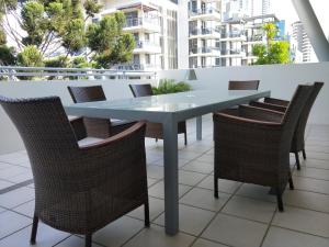 a blue table and chairs on a balcony at Trilogy Surfers Paradise in Gold Coast