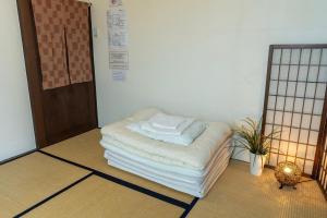 Postel nebo postele na pokoji v ubytování Sendai Guest House UMEBACHI