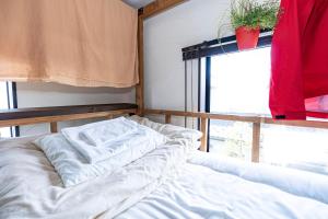 Postel nebo postele na pokoji v ubytování Sendai Guest House UMEBACHI