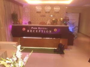 a sign that reads park riser reception in a room at Hotel Park Riviera in Guwahati