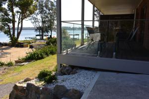 a view from the balcony of a house overlooking the ocean at Dungowan Holiday Accommodation in Erowal Bay
