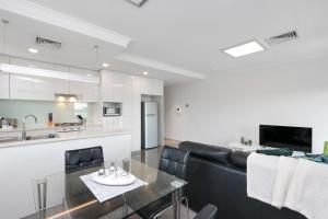 a living room with a white counter top and a black coffee table at 188 Apartments in Perth