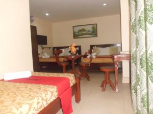 a hotel room with a bed and a table and chairs at Bora Sky Hotel in Boracay