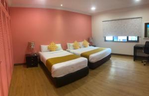 Ένα ή περισσότερα κρεβάτια σε δωμάτιο στο Rimbun Suites & Residences