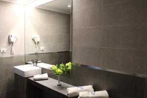 a bathroom with a sink and a mirror at President Hotel in Jounieh +30 photos