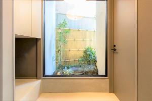 福岡市にあるMUSUBI HOTEL MACHIYA Haruyoshiの窓付きのガラスドア