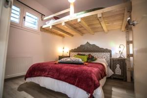 - une chambre avec un grand lit et une couverture rouge dans l'établissement MULHACEN, à Sierra Nevada