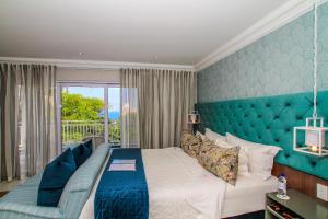 a bedroom with a large bed and a balcony at Sandals Guest House in Durban +124 photos