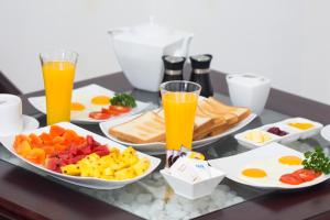 una bandeja de alimentos para el desayuno con zumo de naranja y huevos en Cloud Nine Wilpattu by Aaradhya, en Wilpattu