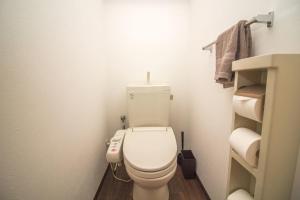 a small bathroom with a toilet and a sink at Nakayoshi Stay 401 in Osaka
