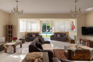 a large living room with couches and a tv at EvMar Villa in Rhodes Town +22 photos