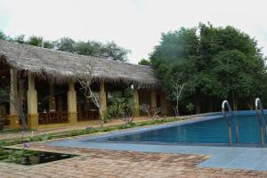 a resort with a swimming pool in front of a building at Cloud Nine Wilpattu by Aaradhya in Wilpattu