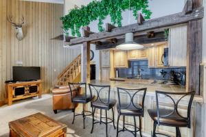 a kitchen with a table and chairs and a television at Mt Bachelor Village Ski House # 262 in Bend