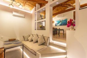 a living room with a couch and a table at CAMARA SUITES in Andros