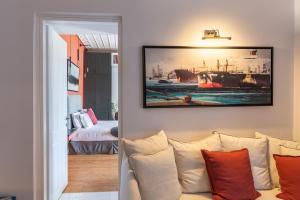 a living room with a couch and a painting on the wall at CAMARA SUITES in Andros