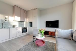a living room with a couch and a table at Flamingo Beach Apartment in Gdańsk +32 photos