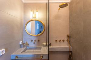 a bathroom with a sink and a mirror at CAMARA SUITES in Andros