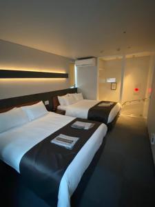 Voodi või voodid majutusasutuse Hotel 草石庵 toas