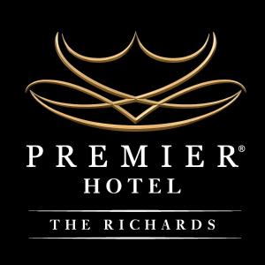 a hotel sign with a gold logo on a black background at Premier Hotel The Richards in Richards Bay