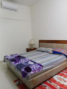 a large bed sitting on top of a room at Homestay An-nur in Alor Setar