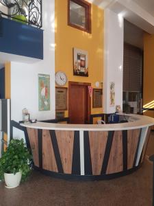 an office lobby with a round counter and a clock at Acropol Beach Hotel in Antalya