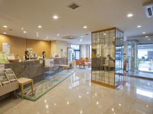 a lobby of a store with a counter and tables at Bell's Inn Maebashi in Maebashi