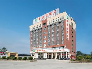 a large building with a hotel in front of it at Vienna Hotel (Jieyang Longwei) in Jieyang