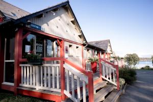 a building with a red fence in front of it at Kyriad Saint-Malo Dinard in La Richardais
