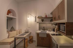 a small kitchen with a sink and a couch at CAMARA SUITES in Andros