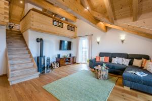 a living room with a couch and a staircase at Edlmann-Hof in Obing