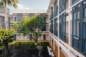an exterior view of a building with a courtyard with trees at SOOKNIRUND HOTEL in Chiang Rai +101 photos