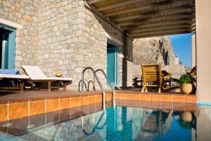 a house with a swimming pool and a patio at Petra Boutique Homes in Aryinónda