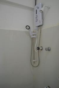 a shower in a bathroom with a shower head at D'Villa Garden House in Jaffna