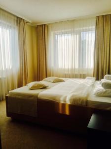 
a hotel room with two beds and a window at Garni Hotel Nevski in Belgrade
